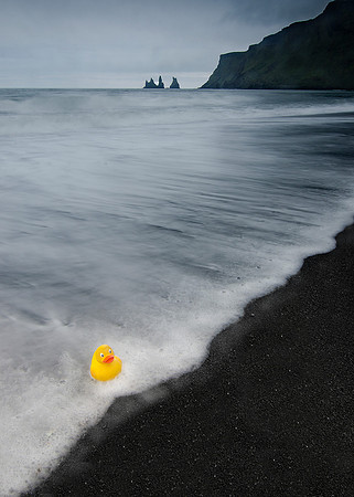 Rubber Ducky doesn't appreciate the Photographer playing "Wave Roulette" with his life              Photographer's note: I didn't have to sacrifice my last pair of dry shoes to save the Ducky, but I d